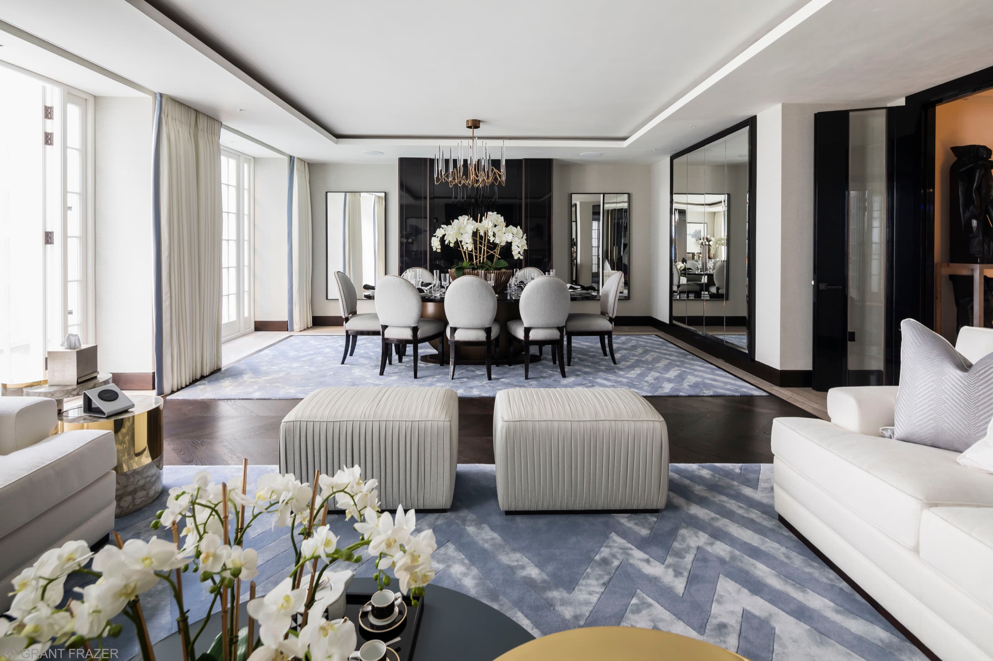 A lateral reception room opening to a formal dining area in a K10 Group residence