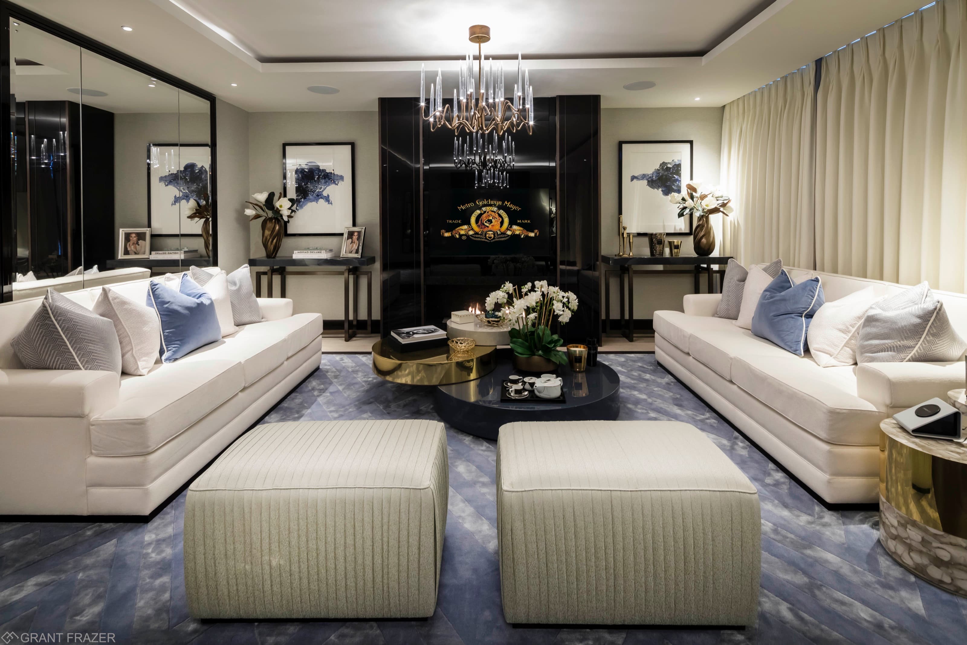 A drawing room with facing sofas and a chandelier in a K10 Group residence