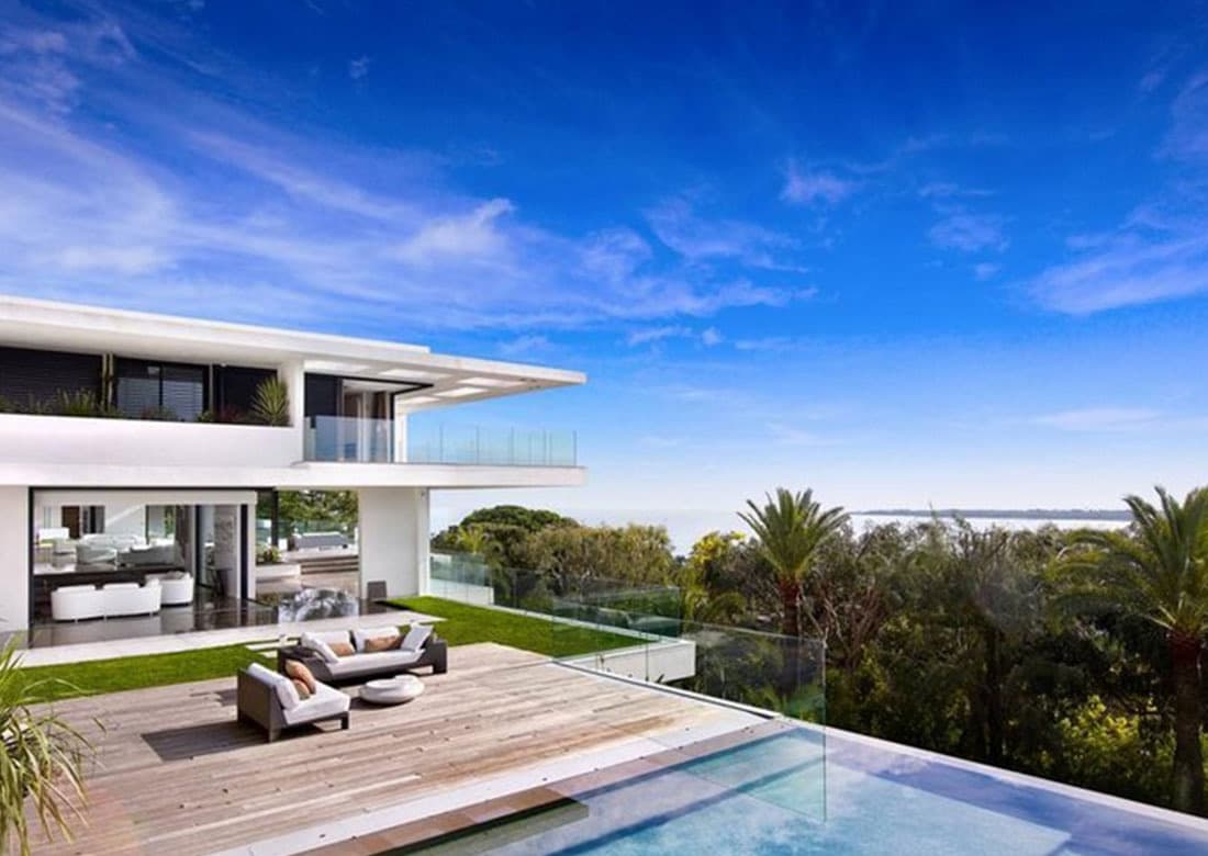 A modern villa terrace with an infinity pool overlooking the sea